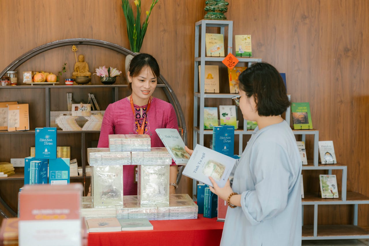 Two women engaging in a bookstore, exploring literary selections on display.